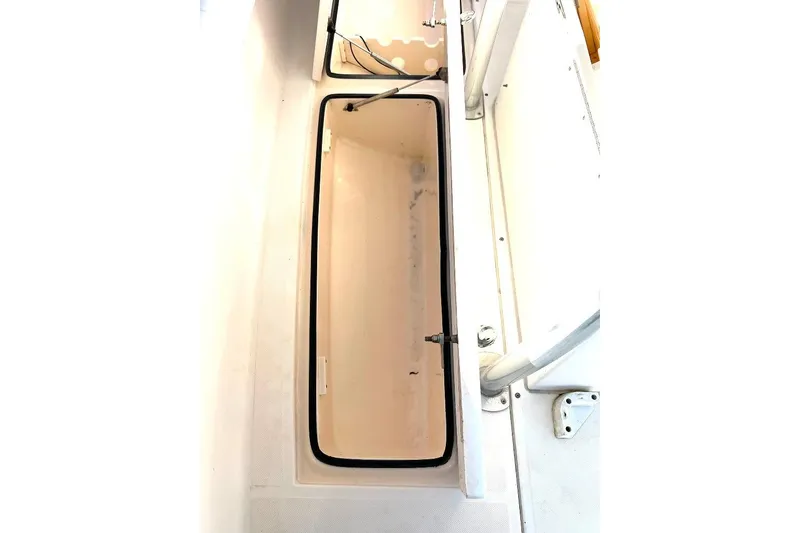 Slide: The Image of 2008 McKee Craft Freedom 28 FS/CC boat storage compartment, open and empty. - 13