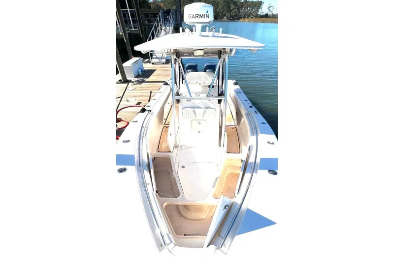 Slide: The Image of 2008 McKee Craft Freedom 28 FS/CC boat docked by the water. - 18