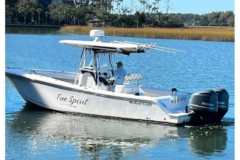 Slide: The Image of 2008 McKee Craft Freedom 28 FS/CC boat on calm water, labeled "Free Spirit." - 2