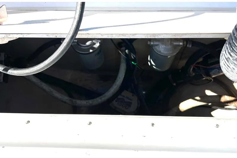 Slide: The Image of 2008 McKee Craft Freedom 28 FS/CC boat engine compartment with visible hoses and filters. - 20