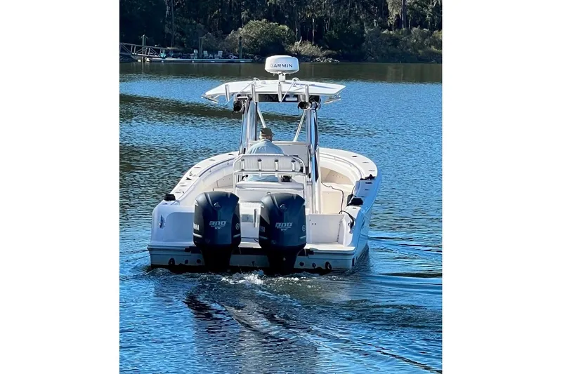 Slide: The Image of 2008 McKee Craft Freedom 28 FS/CC boat on calm water, rear view with dual engines. - 3
