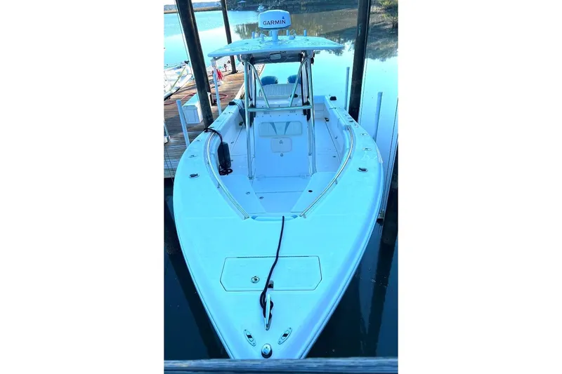 Slide: The Image of 2008 McKee Craft Freedom 28 FS/CC boat docked, featuring a sleek design and spacious deck. - 6