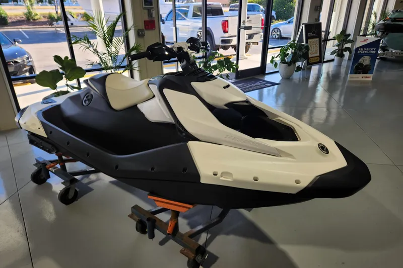 Slide: The Image of 2024 Seadoo SPARK TRIXX 1 UP jet ski displayed indoors, front view. - 3