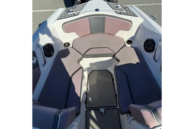 Slide: The Image of 2017 Scarab 215 HO Impulse boat interior with cushioned seating and speakers. - 10