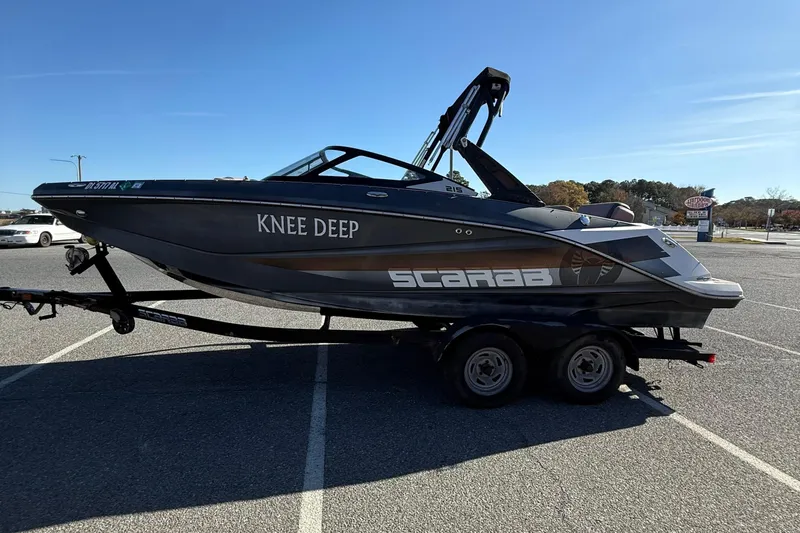 Slide: The Image of 2017 Scarab 215 HO Impulse boat on trailer in parking lot, side view. - 5