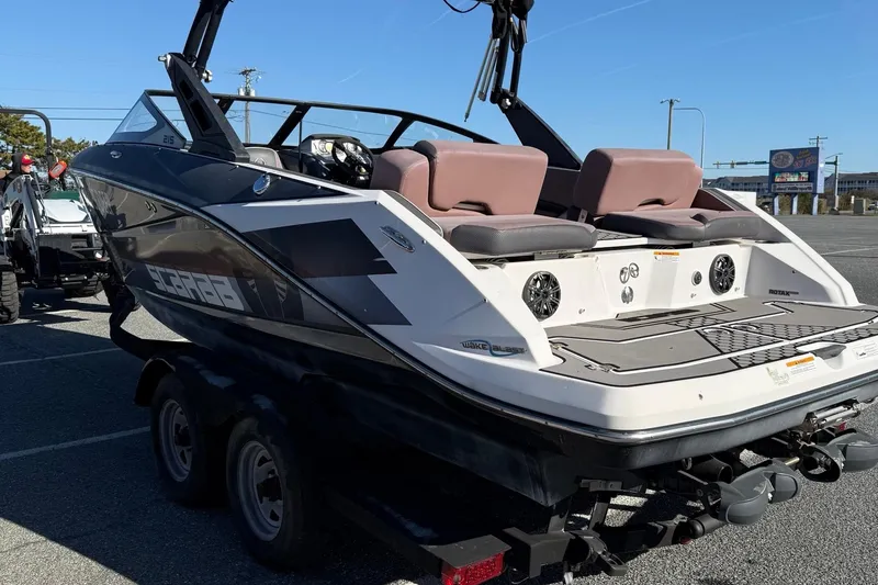 Slide: The Image of 2017 Scarab 215 HO Impulse boat on trailer, rear view, parked outdoors. - 6