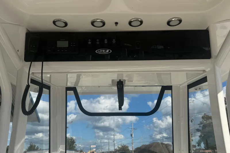 Slide: The Image of 2022 Sea Hunt Gamefish 25 boat interior with control panel and clear sky view. - 15