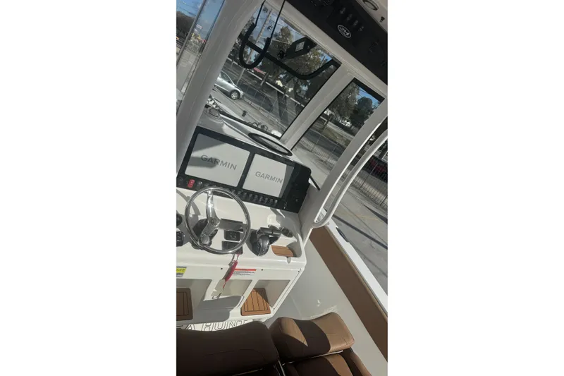 Slide: The Image of 2022 Sea Hunt Gamefish 25 boat dashboard with Garmin navigation displays. - 16
