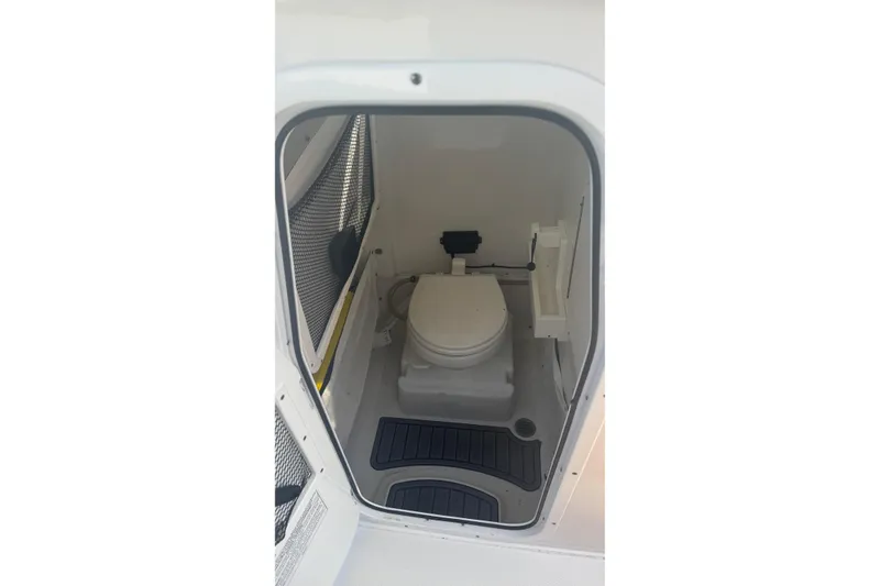 Slide: The Image of 2022 Sea Hunt Gamefish 25 boat interior with compact marine toilet. - 18