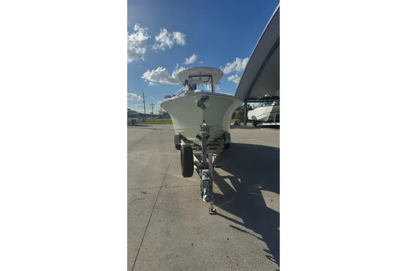 Slide: The Image of 2022 Sea Hunt Gamefish 25 boat on trailer under clear blue sky. - 6