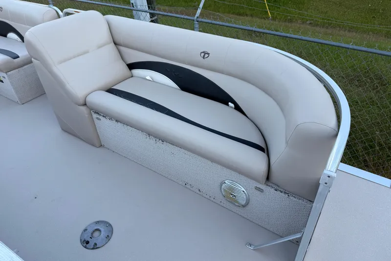 Slide: The Image of 2011 Tahoe Pontoon 2485 DRL boat seating with beige upholstery and speaker detail. - 3