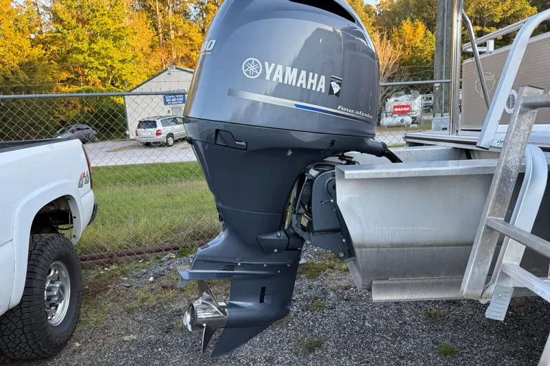 Slide: The Image of 2011 Tahoe Pontoon 2485 DRL with Yamaha outboard motor in a parking area. - 8