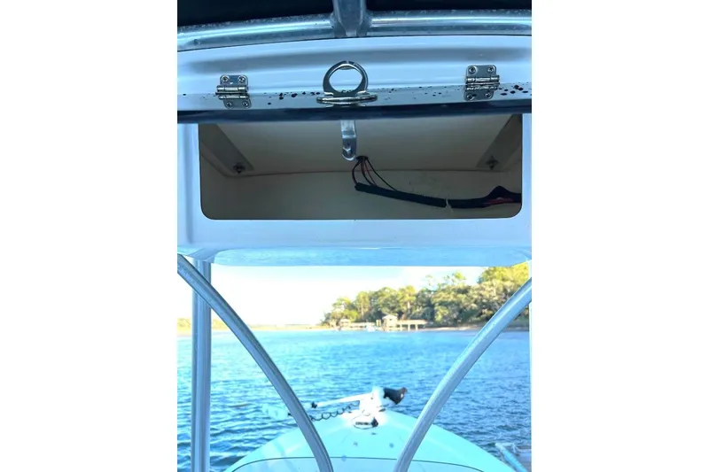 Slide: The Image of Open storage compartment on 2015 BlackJack 224 boat, with scenic water view. - 15