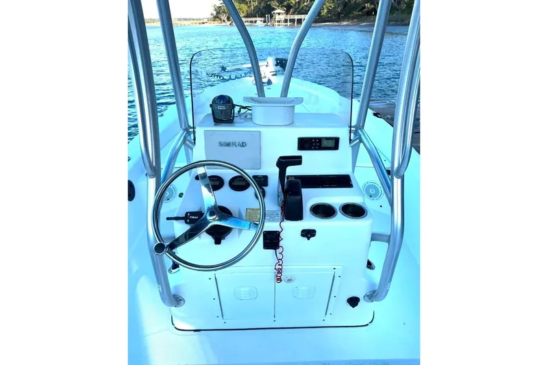 Slide: The Image of Center console of a 2015 BlackJack 224 boat with steering wheel and controls. - 16