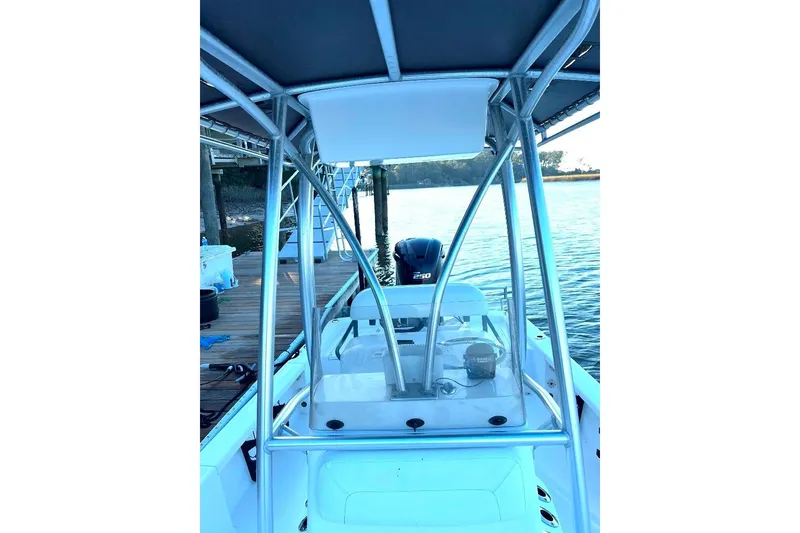 Slide: The Image of 2015 BlackJack 224 boat docked by the water, featuring a sleek design and powerful engine. - 17