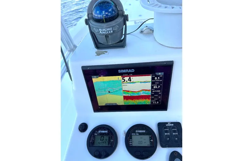 Slide: The Image of Boat dashboard with Simrad display, compass, and Yamaha gauges on a 2015 BlackJack 224. - 18
