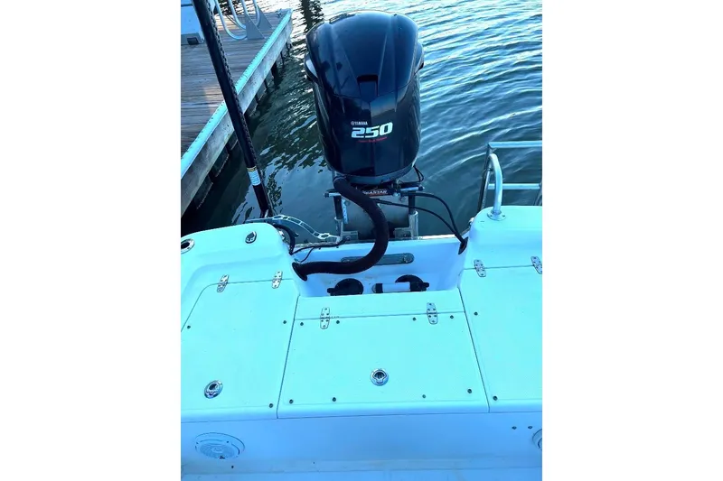Slide: The Image of 2015 BlackJack 224 boat with Yamaha 250 outboard motor, docked on calm water. - 20