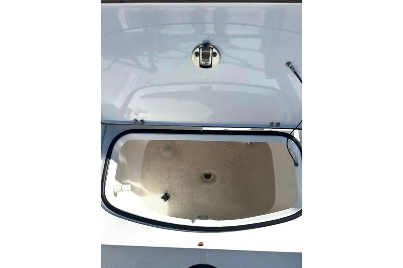 Slide: The Image of Open storage compartment on a 2015 BlackJack 224 boat, showing interior details. - 22