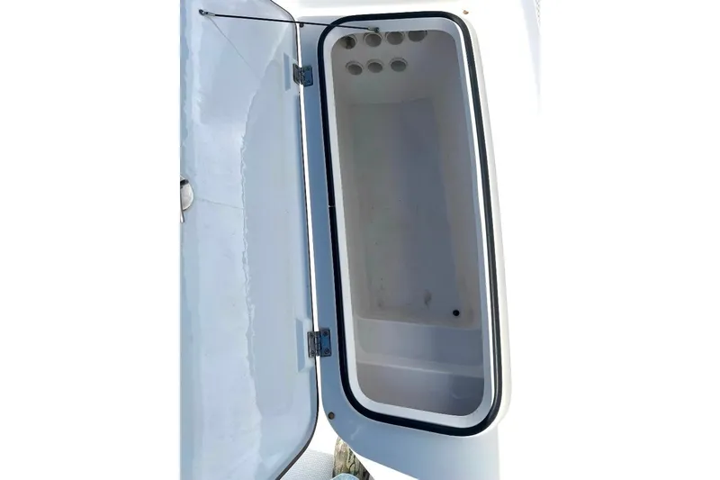Slide: The Image of Open storage compartment on a 2015 BlackJack 224 boat, showcasing interior space. - 25