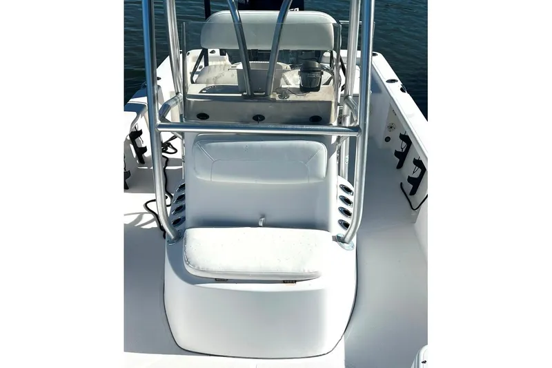 Slide: The Image of 2015 BlackJack 224 boat interior with seating and rod holders, on calm water. - 29