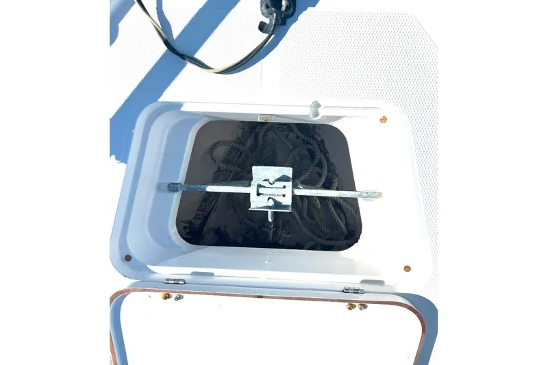 Slide: The Image of Open storage compartment on a 2015 BlackJack 224 boat, containing coiled rope. - 30