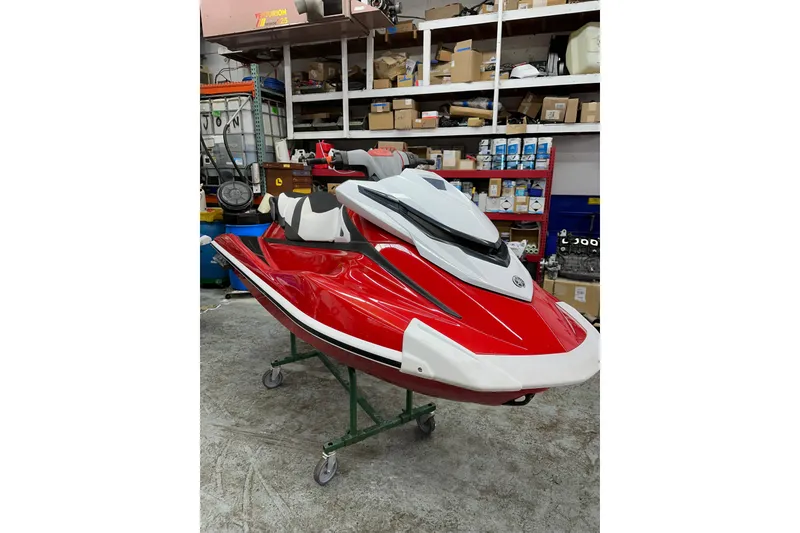 The Image of 2018 Yamaha WaveRunner GP1800 in a workshop, red and white design. - 1
