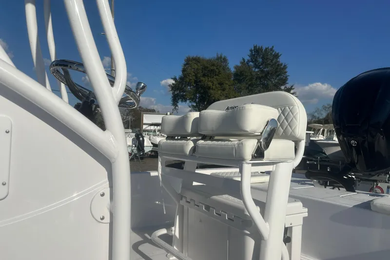 Slide: The Image of 2026 Action Craft 22 Bay boat interior with white seating and steering wheel. - 15