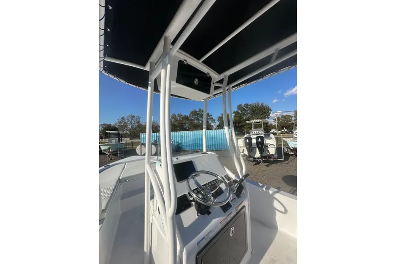 Slide: The Image of 2026 Action Craft 22 Bay boat console with steering wheel and canopy. - 17