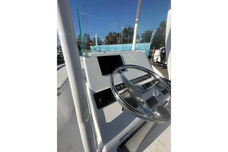 Slide: The Image of 2026 Action Craft 22 Bay boat console with steering wheel and control panel. - 18