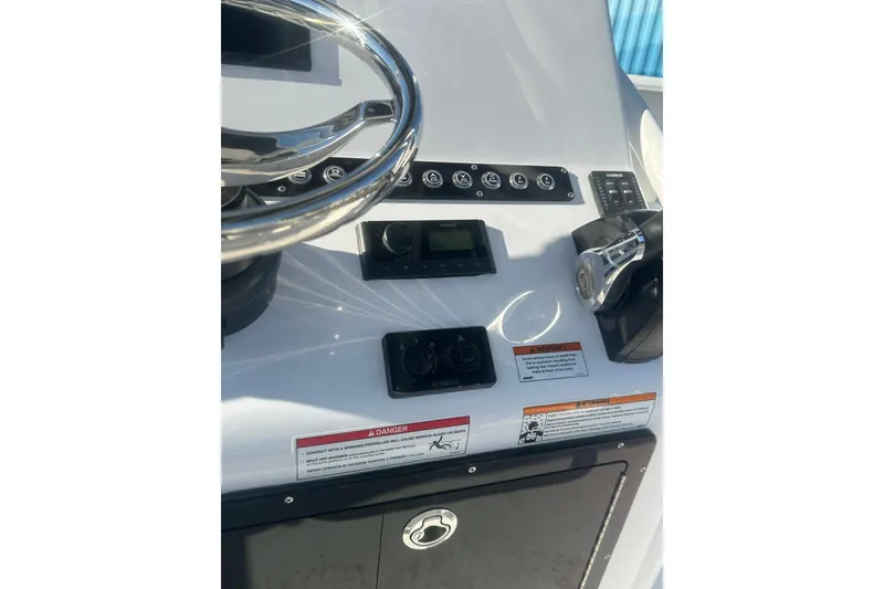 Slide: The Image of 2026 Action Craft 22 Bay boat dashboard with steering wheel and control panel. - 20