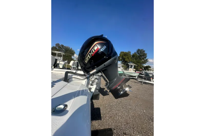 Slide: The Image of 2026 Action Craft 22 Bay boat with Yamaha outboard motor, parked outdoors. - 22