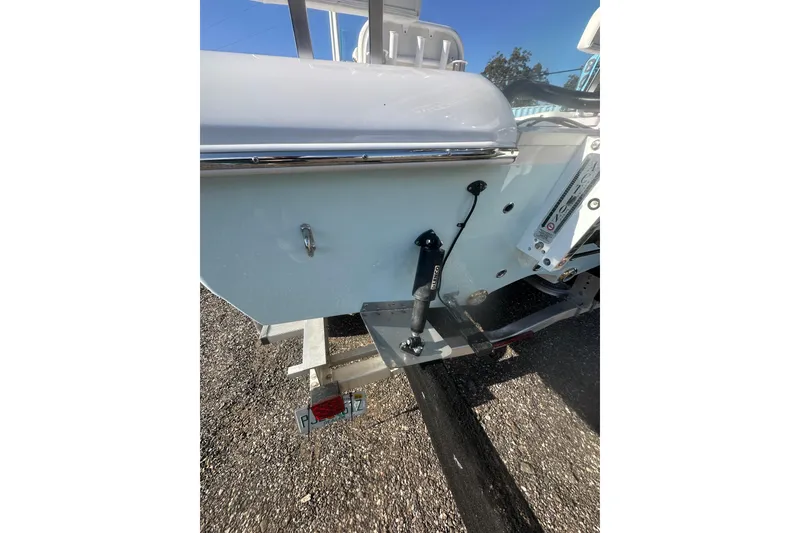 Slide: The Image of 2026 Action Craft 22 Bay boat on trailer, rear view, showing hull and trim details. - 24