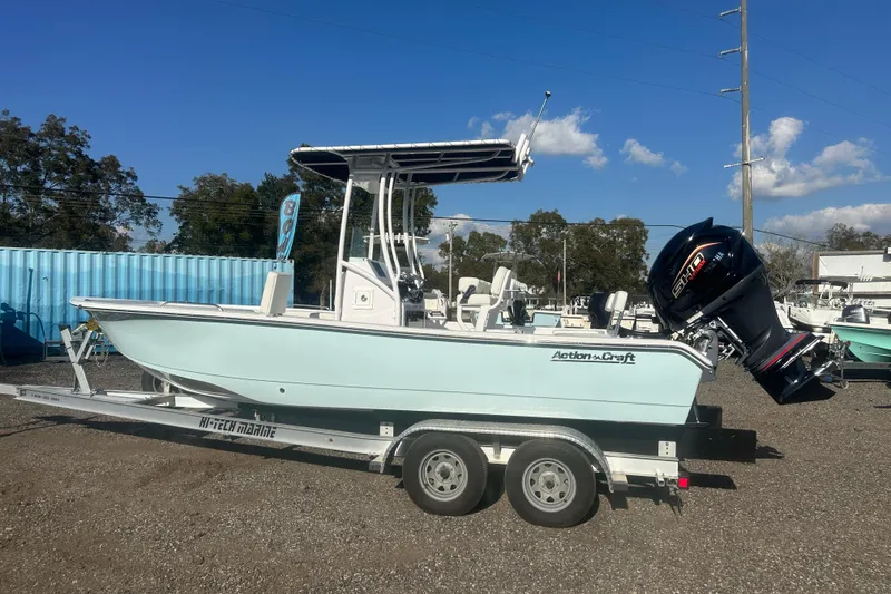 Slide: The Image of 2026 Action Craft 22 Bay boat on trailer, parked outdoors under clear blue sky. - 3