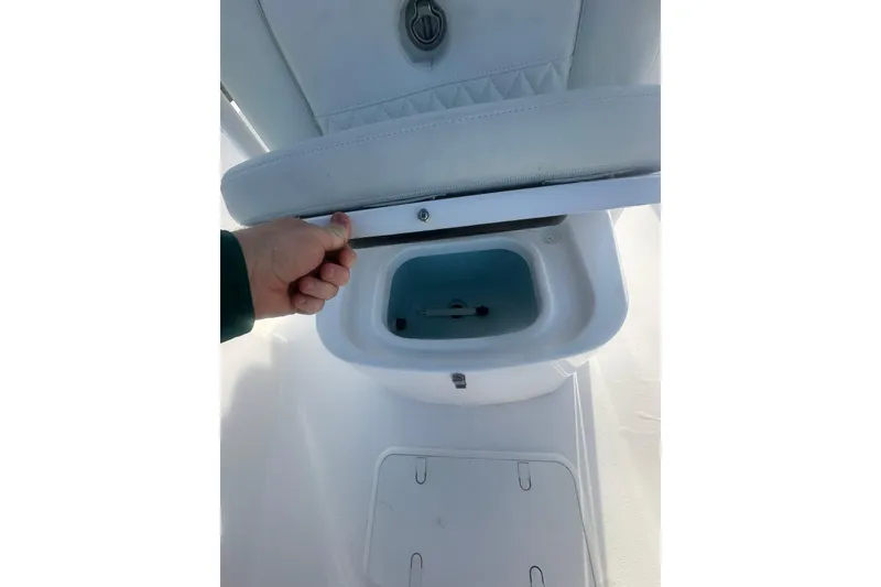 Slide: The Image of 2026 Action Craft 22 Bay boat seat storage compartment being opened. - 33