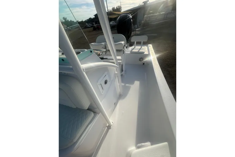 Slide: The Image of 2026 Action Craft 22 Bay boat interior with seating and console, sunlit view. - 42