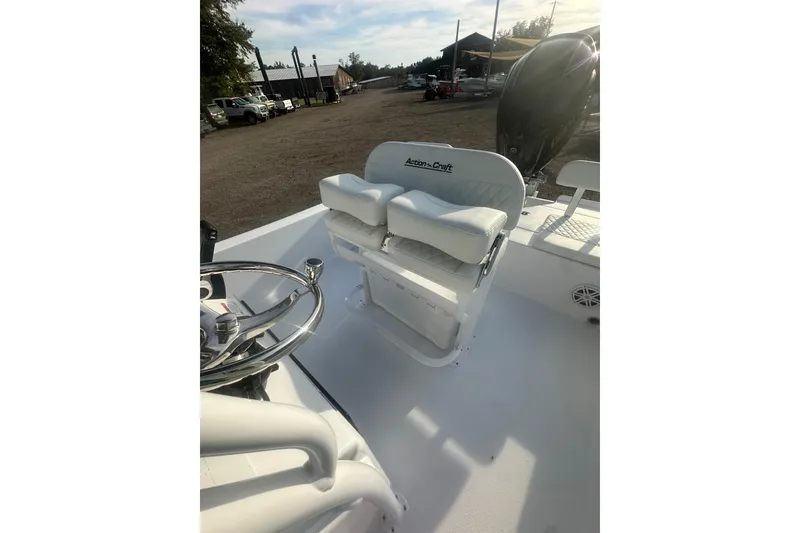 Slide: The Image of 2026 Action Craft 22 Bay boat interior with steering wheel and cushioned seating. - 44