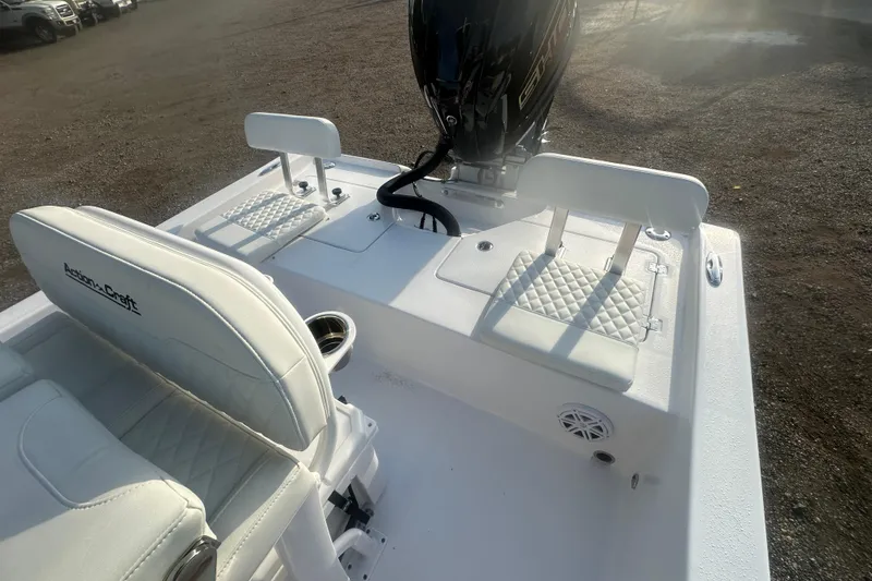 Slide: The Image of 2026 Action Craft 22 Bay boat interior with white seating and motor. - 45