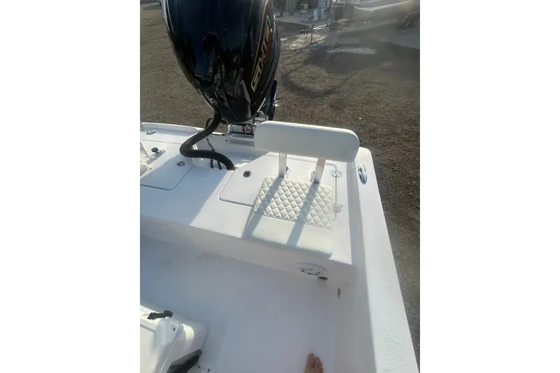 Slide: The Image of 2026 Action Craft 22 Bay boat with cushioned seating and outboard motor. - 46