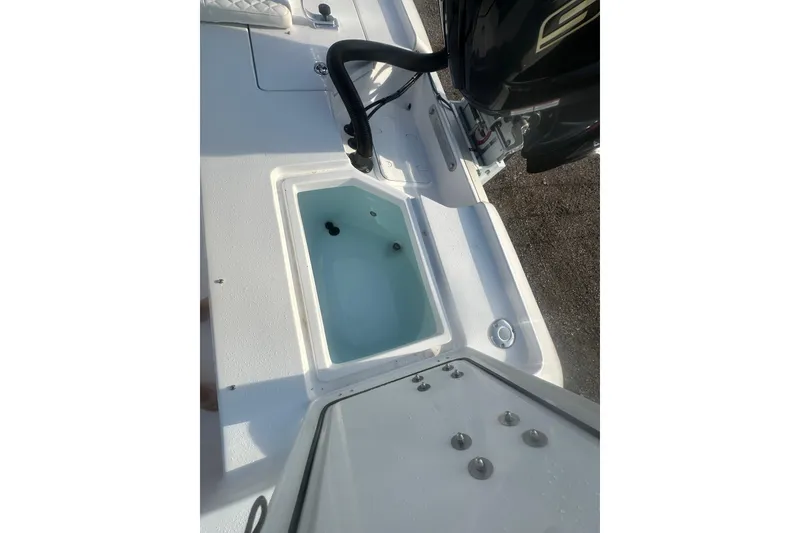 Slide: The Image of 2026 Action Craft 22 Bay boat with open livewell and visible engine. - 47