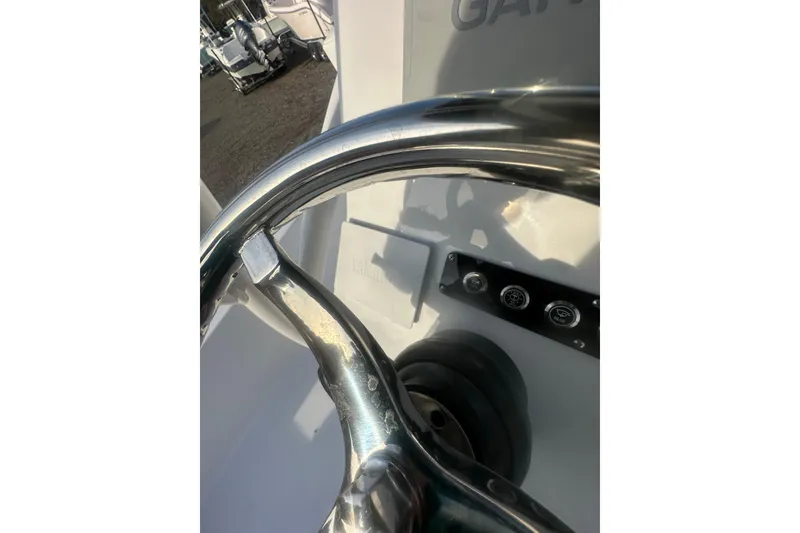 Slide: The Image of Steering wheel of 2026 Action Craft 22 Bay boat, showcasing control panel details. - 55