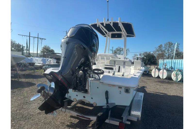 Slide: The Image of 2026 Action Craft 22 Bay boat with outboard motor, parked on a trailer. - 6