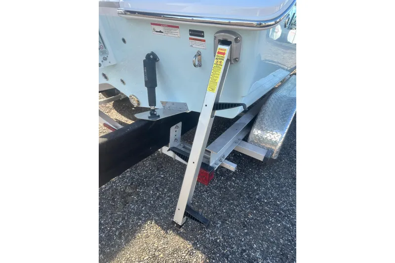 Slide: The Image of 2026 Action Craft 22 Bay boat trailer with step ladder and safety warnings. - 7