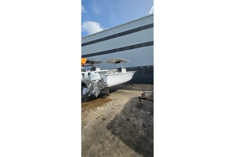 The Image of 2007 Southport 26 Center Console boat on dry dock near industrial building. - 1