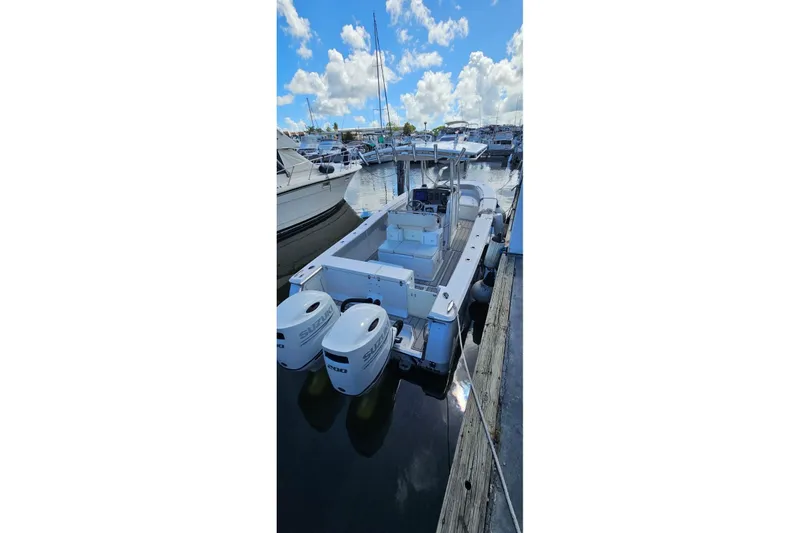 Slide: The Image of 2007 Southport 26 Center Console boat docked with twin Suzuki engines. - 12