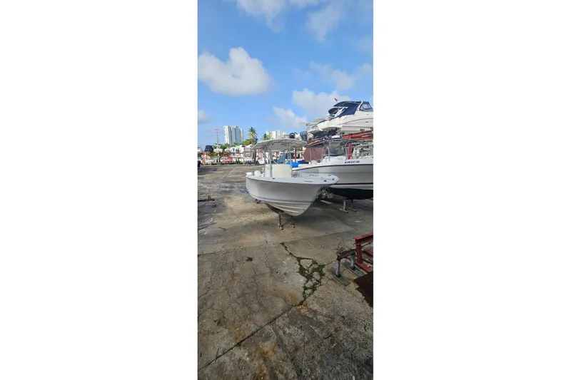 Slide: The Image of 2007 Southport 26 Center Console boat on dry dock under a clear blue sky. - 2