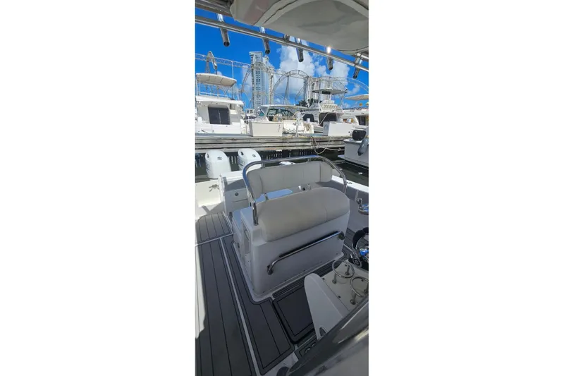 Slide: The Image of 2007 Southport 26 Center Console boat interior at marina, featuring seating and helm. - 3