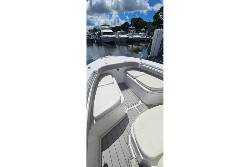 Slide: The Image of 2007 Southport 26 Center Console boat with cushioned seating, docked at marina. - 4