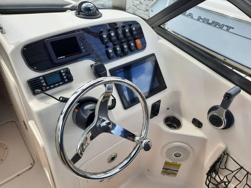 Slide: The Image of Steering console of 2016 Grady-White Freedom 205 boat with navigation controls and display. - 15
