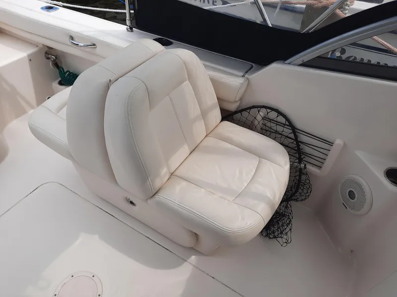 Slide: The Image of 2016 Grady-White Freedom 205 boat with white leather seating and fishing net. - 20
