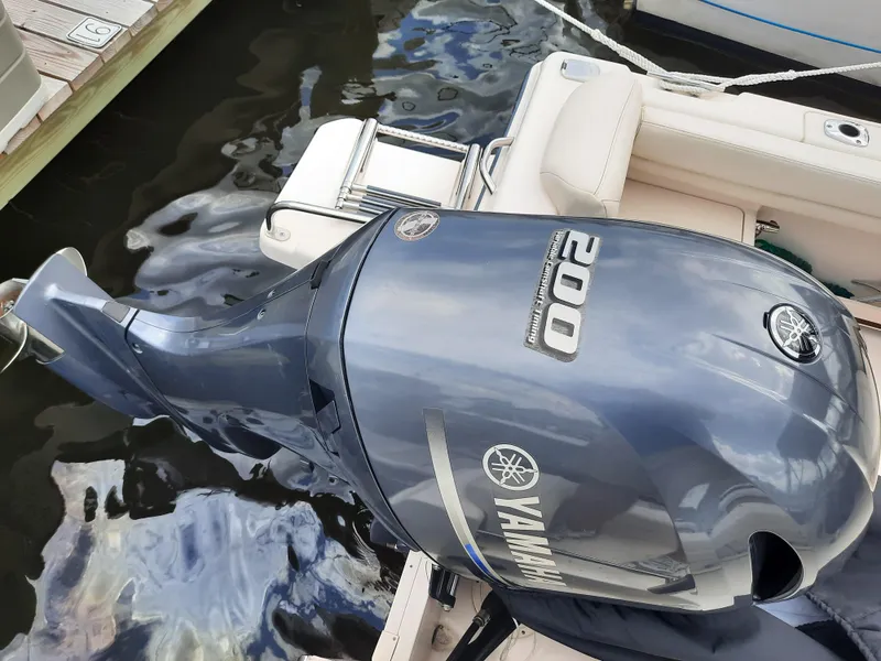 Slide: The Image of Yamaha 200 outboard motor on 2016 Grady-White Freedom 205 boat, docked by water. - 26
